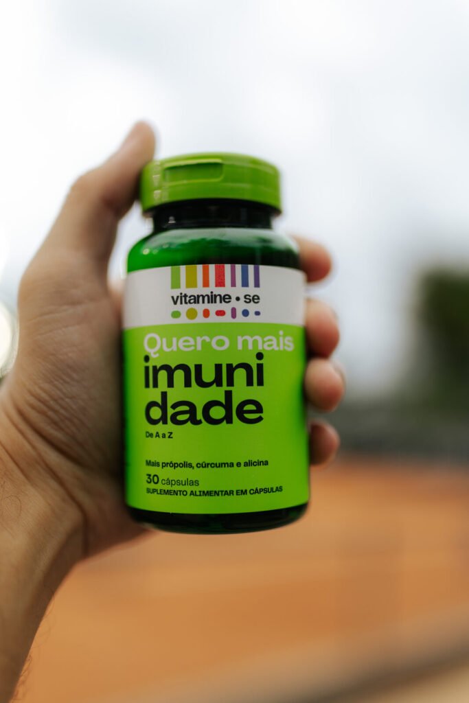 Pote Quero Mais Imunidade da linha Vitamine-se da EMS com o saibro da quadra do Rio Open 2026 ao fundo